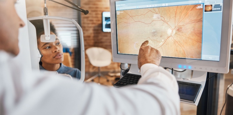 Optometrist examining eye 